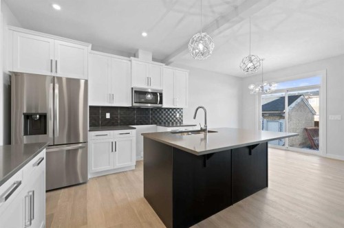 67 Agate Road, Cochrane, AB - Indoor Photo Showing Kitchen With Upgraded Kitchen