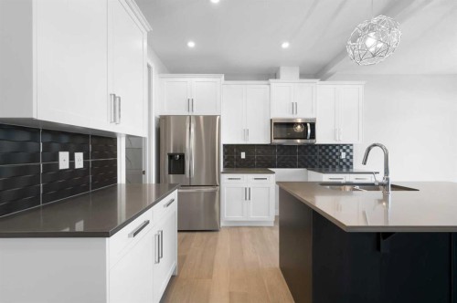 67 Agate Road, Cochrane, AB - Indoor Photo Showing Kitchen With Upgraded Kitchen
