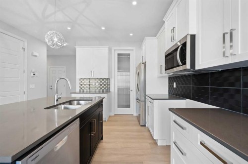 67 Agate Road, Cochrane, AB - Indoor Photo Showing Kitchen With Double Sink With Upgraded Kitchen