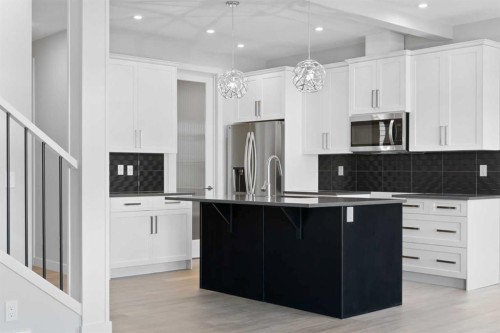 67 Agate Road, Cochrane, AB - Indoor Photo Showing Kitchen With Upgraded Kitchen