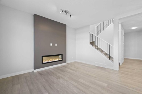 67 Agate Road, Cochrane, AB - Indoor Photo Showing Living Room With Fireplace