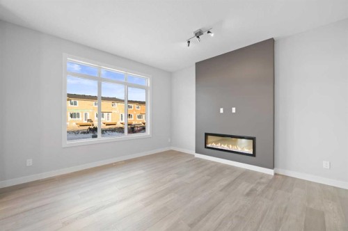 67 Agate Road, Cochrane, AB - Indoor Photo Showing Living Room With Fireplace