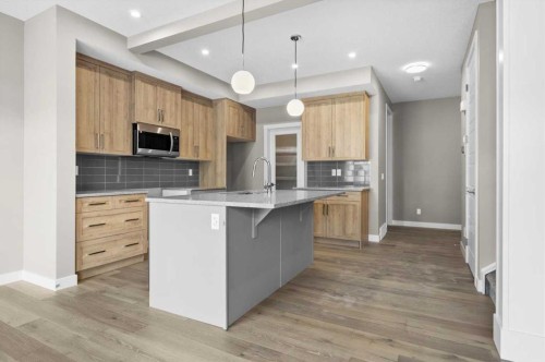 67 Agate Road, Cochrane, AB - Indoor Photo Showing Kitchen With Upgraded Kitchen