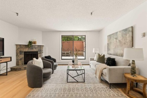 101-930 18 Avenue Sw, Calgary, AB - Indoor Photo Showing Living Room With Fireplace