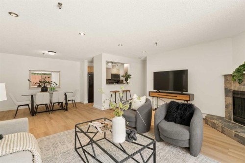 101-930 18 Avenue Sw, Calgary, AB - Indoor Photo Showing Living Room With Fireplace