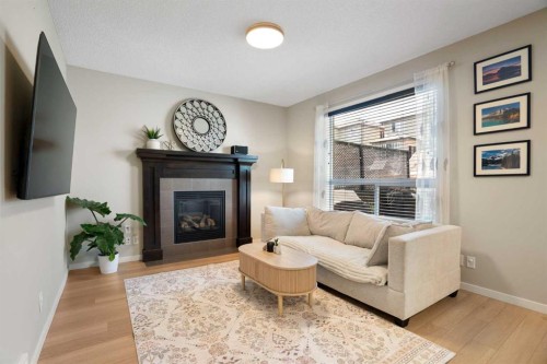 1258 New Brighton Drive Se, Calgary, AB - Indoor Photo Showing Living Room With Fireplace