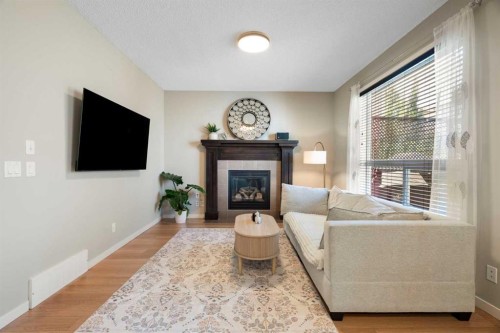 1258 New Brighton Drive Se, Calgary, AB - Indoor Photo Showing Living Room With Fireplace
