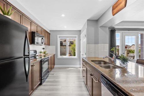 52 Windstone Green Sw, Airdrie, AB - Indoor Photo Showing Kitchen With Double Sink