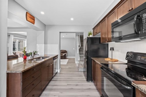 52 Windstone Green Sw, Airdrie, AB - Indoor Photo Showing Kitchen With Double Sink