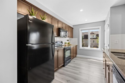52 Windstone Green Sw, Airdrie, AB - Indoor Photo Showing Kitchen With Double Sink
