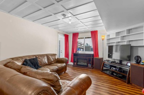 317 Mcleod Crescent, Diamond Valley, AB - Indoor Photo Showing Living Room With Fireplace