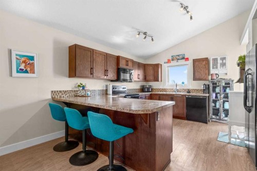 317 Mcleod Crescent, Diamond Valley, AB - Indoor Photo Showing Kitchen With Double Sink