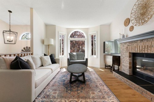34 West Mcmanus Road, Cochrane, AB - Indoor Photo Showing Living Room With Fireplace
