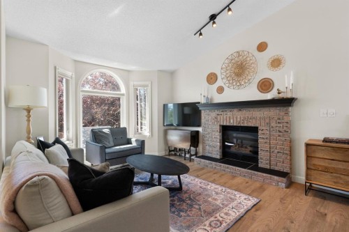 34 West Mcmanus Road, Cochrane, AB - Indoor Photo Showing Living Room With Fireplace