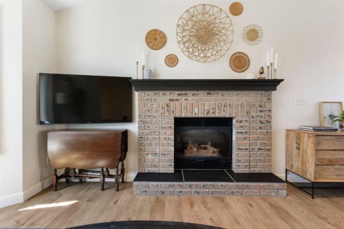 34 West Mcmanus Road, Cochrane, AB - Indoor Photo Showing Living Room With Fireplace