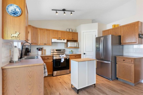 34 West Mcmanus Road, Cochrane, AB - Indoor Photo Showing Kitchen With Double Sink