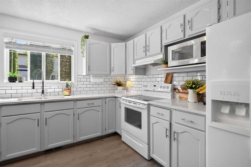 66 Canoe Close Sw, Airdrie, AB - Indoor Photo Showing Kitchen With Double Sink