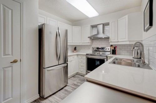 1114-1818 Simcoe Boulevard Sw, Calgary, AB - Indoor Photo Showing Kitchen With Stainless Steel Kitchen With Double Sink