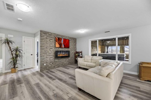 6 Valarosa Cove, Didsbury, AB - Indoor Photo Showing Living Room With Fireplace