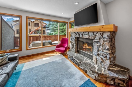 4-813 5Th Street, Canmore, AB - Indoor Photo Showing Living Room With Fireplace
