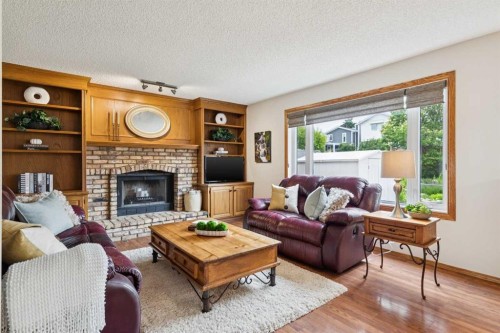 410 Millrise Drive Sw, Calgary, AB - Indoor Photo Showing Living Room With Fireplace