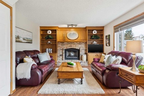 410 Millrise Drive Sw, Calgary, AB - Indoor Photo Showing Living Room With Fireplace
