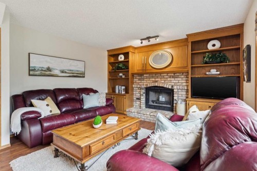 410 Millrise Drive Sw, Calgary, AB - Indoor Photo Showing Living Room With Fireplace