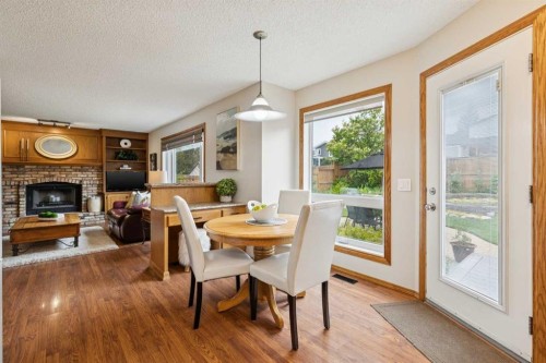 410 Millrise Drive Sw, Calgary, AB - Indoor Photo Showing Dining Room With Fireplace