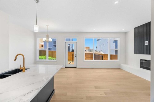 63 Annette Rise Nw, Calgary, AB - Indoor Photo Showing Kitchen With Fireplace With Double Sink