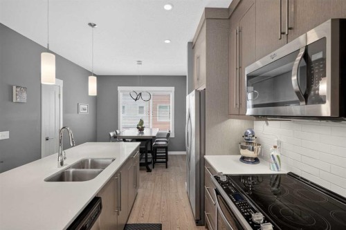 18-111 Rainbow Falls Gate, Chestermere, AB - Indoor Photo Showing Kitchen With Double Sink With Upgraded Kitchen