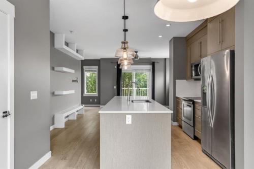43-111 Rainbow Falls Gate, Chestermere, AB - Indoor Photo Showing Kitchen With Stainless Steel Kitchen