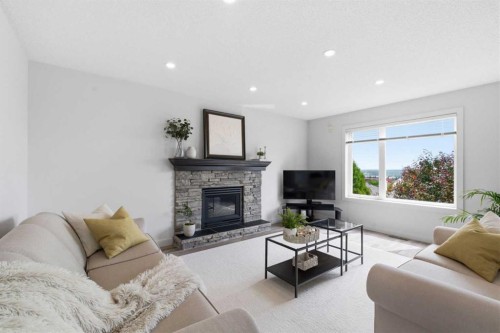 271 Sienna Park View Sw, Calgary, AB - Indoor Photo Showing Living Room With Fireplace