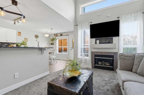 121 Canoe Square Sw, Airdrie, AB - Indoor Photo Showing Living Room With Fireplace