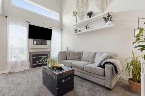 121 Canoe Square Sw, Airdrie, AB - Indoor Photo Showing Living Room With Fireplace