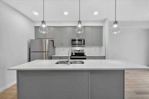 101-200 Shawnee Square Sw, Calgary, AB - Indoor Photo Showing Kitchen With Stainless Steel Kitchen With Double Sink With Upgraded Kitchen