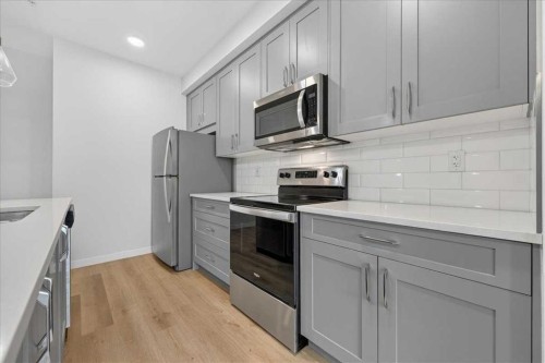 101-200 Shawnee Square Sw, Calgary, AB - Indoor Photo Showing Kitchen With Stainless Steel Kitchen