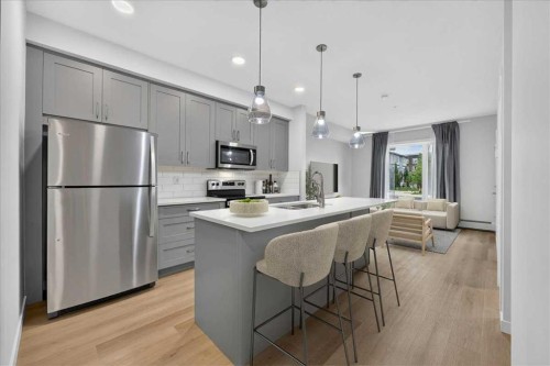 101-200 Shawnee Square Sw, Calgary, AB - Indoor Photo Showing Kitchen With Stainless Steel Kitchen With Upgraded Kitchen