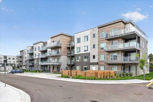 101-200 Shawnee Square Sw, Calgary, AB - Outdoor With Balcony With Facade