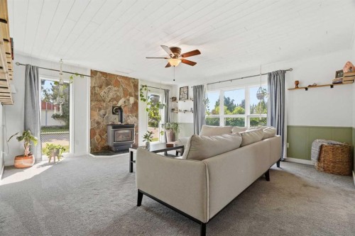 302 Frontenac Avenue Nw, Diamond Valley, AB - Indoor Photo Showing Living Room With Fireplace