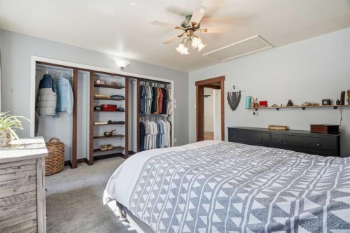 302 Frontenac Avenue Nw, Diamond Valley, AB - Indoor Photo Showing Bedroom