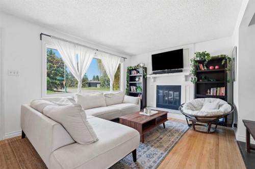 96 Waterloo Drive Sw, Calgary, AB - Indoor Photo Showing Living Room With Fireplace