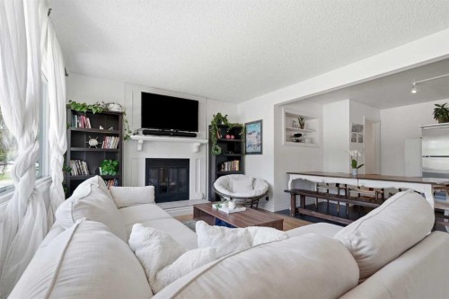 96 Waterloo Drive Sw, Calgary, AB - Indoor Photo Showing Living Room With Fireplace