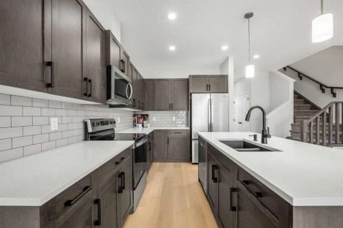 209 Bridgeport Gate North, Chestermere, AB - Indoor Photo Showing Kitchen With Double Sink With Upgraded Kitchen