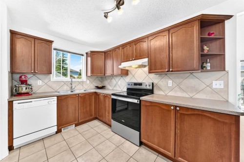 619 Country Village Cape Ne, Calgary, AB - Indoor Photo Showing Kitchen With Double Sink