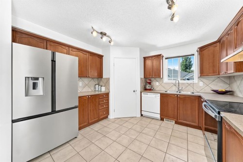 619 Country Village Cape Ne, Calgary, AB - Indoor Photo Showing Kitchen With Double Sink