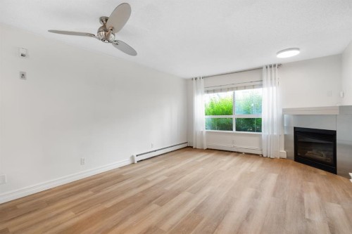 120-25 Richard Place Sw, Calgary, AB - Indoor Photo Showing Living Room With Fireplace