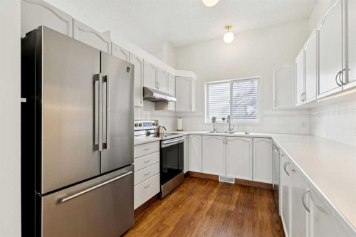 98 River Rock Way Se, Calgary, AB - Indoor Photo Showing Kitchen With Double Sink