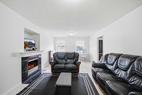 140 Tarawood Grove Ne, Calgary, AB - Indoor Photo Showing Living Room With Fireplace