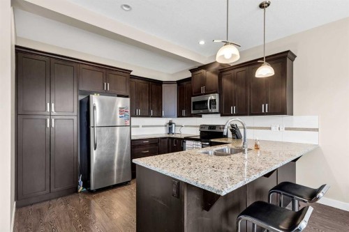 1701-1086 Williamstown Boulevard Nw, Airdrie, AB - Indoor Photo Showing Kitchen With Double Sink With Upgraded Kitchen