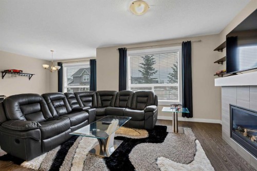 1701-1086 Williamstown Boulevard Nw, Airdrie, AB - Indoor Photo Showing Living Room With Fireplace